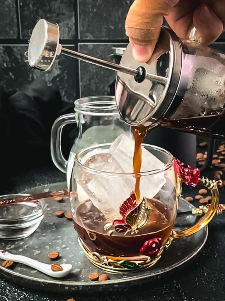 Pouring in the vanilla French press coffee.