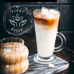 Two gorgeous glasses filled with delicious almond milk latte, placed on marbled plate