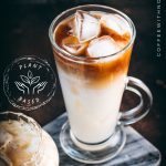 Two gorgeous glasses filled with delicious almond milk latte, placed on marbled plate