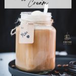 Mason jar filled with delicious iced coffee with vanilla ice cream, placed on a black plate.