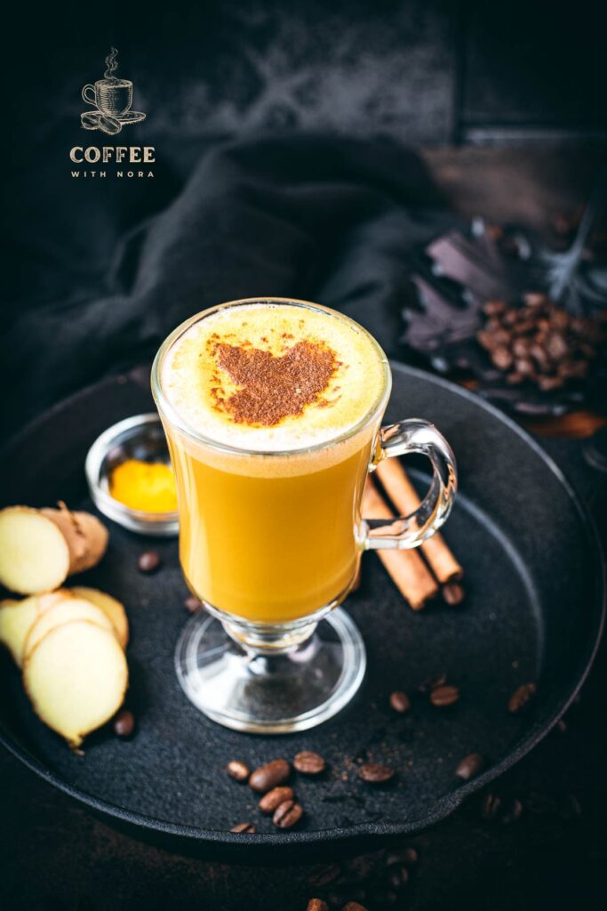 Gorgeous golden turmeric milk coffee. Made with homemade turmeric milk. Dusted with cinnamon.