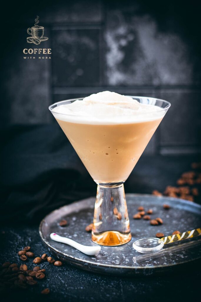 Gorgeous cocktail glass filled with a delicious homemade coffee slushy placed on a metal tray.