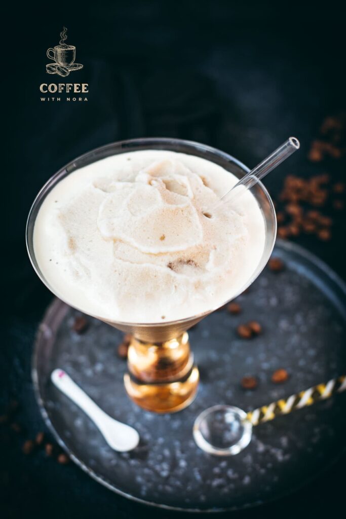 Gorgeous cocktail glass filled with a delicious homemade coffee slushy placed on a metal tray.