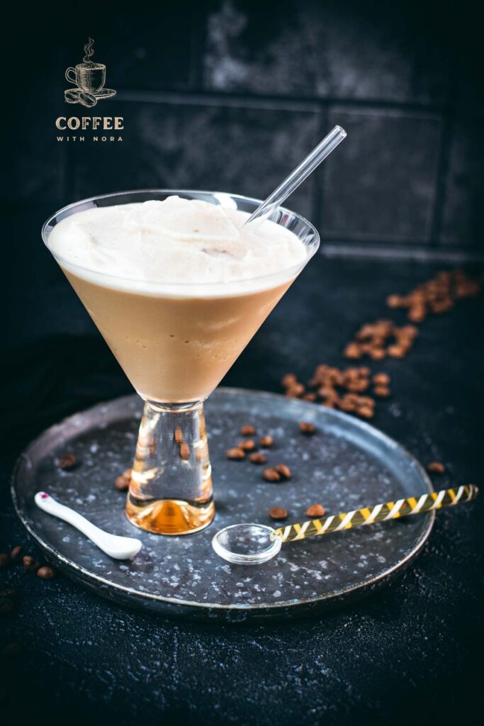 Gorgeous cocktail glass filled with a delicious homemade coffee slushy placed on a metal tray.