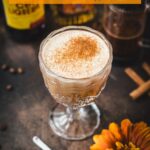 Rich French press Mexican coffee in gorgeous serving glass, placed on brown colored ground, next to orange-colored flower.