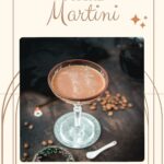 Creamy mocha martini in gorgeous glass, placed on glass coaster on dark ground.