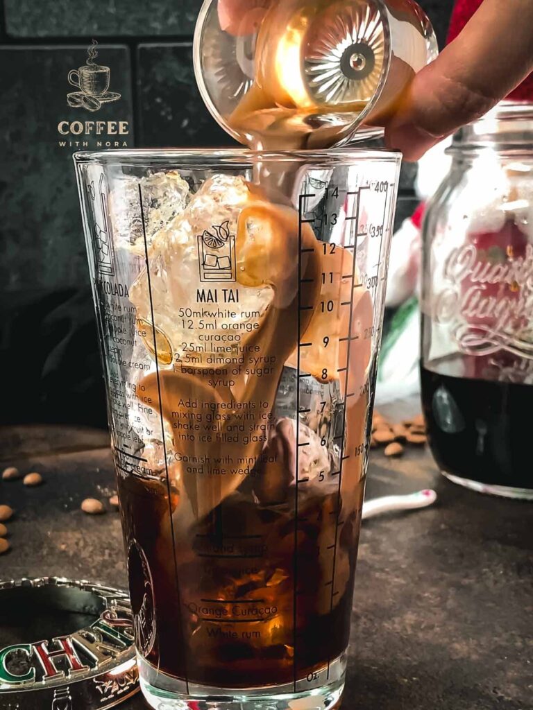 Pouring the chocolate liqueur into the cocktail shaker.