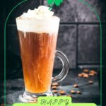 Delicious Irish coffee, topped with whipped cream and sprinkled with cocoa powder, placed on black slate plate.