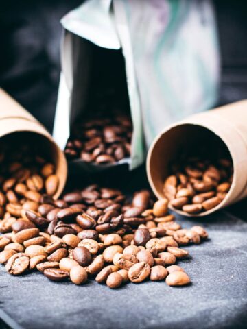 Black slate plate with three different kinds of coffee beans.