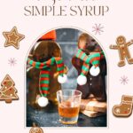 Easy homemade gingerbread simple syrup for coffees and cocktails in a small glass, placed next to two gingerbread man.