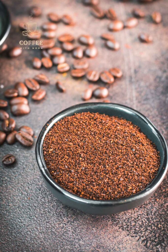 One bowl with ground coffee on brown ground.