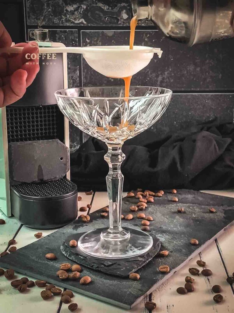 Fine strain the Nespresso martini into the serving glass.