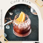 Gorgeous rocks glass, filled with a delicious cold brew negroni, garnished with an orange slice, and placed on a mirrored coaster.