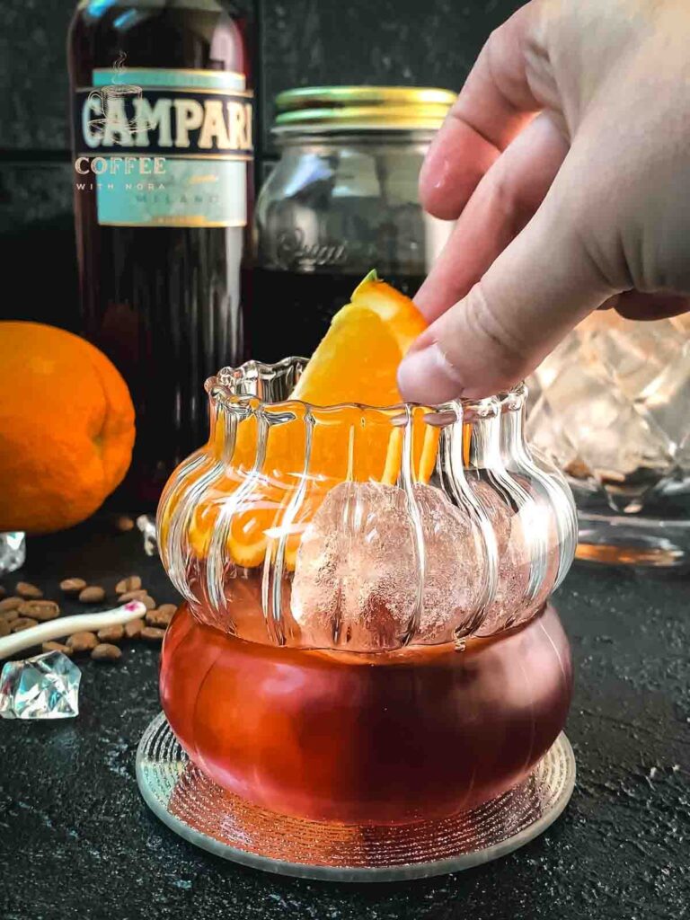 Garnish your cold brew negroni with an orange slice.