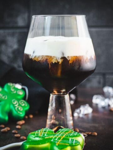 Gorgeous serving glass, filled with delicious iced irish coffee (made with homemade cold brew). Floating on top, a decadent slightly whipped cream.