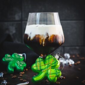 Gorgeous serving glass, filled with delicious iced irish coffee (made with homemade cold brew). Floating on top, a decadent slightly whipped cream.