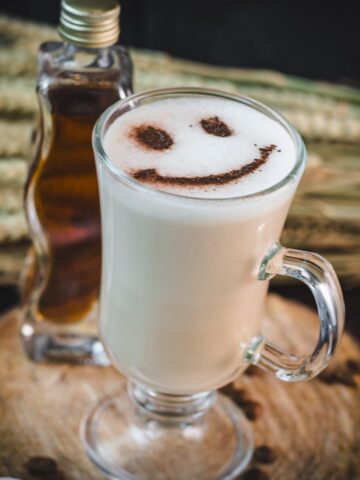 Cute brown sugar oat milk coffee, with a smiley face dusted on top of it.