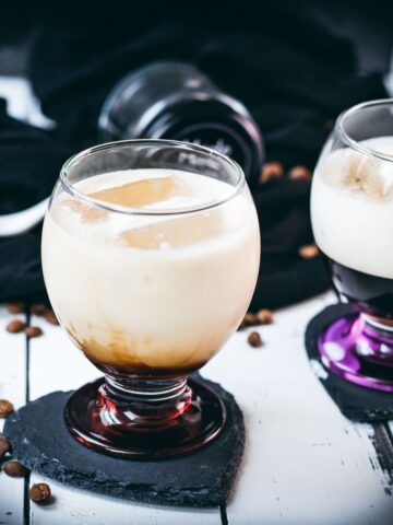 Dairy free cold brew brown sugar white Russian, served in gorgeous glasses with purple and red bottom.
