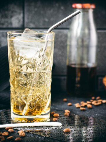 Highball glass filled with a delicious, golden-colored coffee soda.