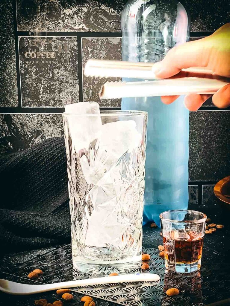 Add cubed ice to the glass.