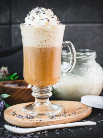 Scrumptious lavender latte, made with homemade lavender coffee creamer. Topped with whipped cream and sprinkled with dried lavender buds.
